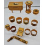 A Lot of 14 various Mauchline Ware items to include Napkin Rings, Needle holder, bank, egg timer and
