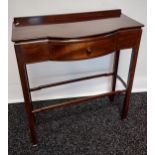 A dark wood console table, with bow front single drawer, raised on square legs, united with