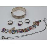 Birmingham silver bangle, silver and enamel souvenir charm bracelet, three silver rings and silver