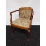An early 20th century mahogany framed bedroom tub chair, material back support and seat flanked by