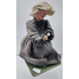 A 19th Century puppet of an elderly lady seated, Dated 1840. [32cm in height]
