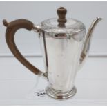 A London silver ornate coffee pot fitted with a wood handle and finial top. [16cm in height]