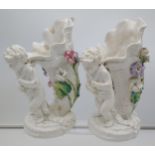 A Pair of 19th century Moore Bros cherub figurine carrying a horn shell vase. [Both as found] [