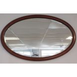 A 19th century oval mantle mirror.