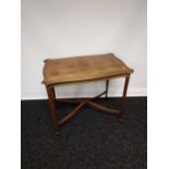 A Late Victorian widow table, supported on square tapered legs upon spade feet, with a X stretcher