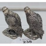A pair of silver plated condiments in the form of eagles