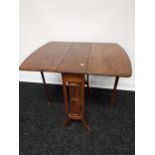 An antique mahogany Sutherland drop leaf table, supported on twin pierced supports [64x60x77cm]