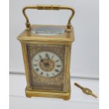Antique Brass cased and bevel glass carriage clock. Designed with an enamel dial. In a working