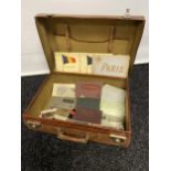 A Vintage leather travel case containing a collection of various souvenir postcards