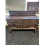 An oak sideboard with raised back detailed with twist and bead decoration