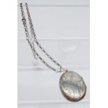 A Large silver locket pendant and curb necklace.