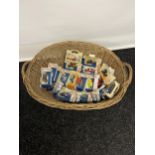 A Vintage wicker linen basket containing a collection of days gone models