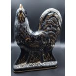 A Bo'ness pottery black lustre cockerel figurine. [31cm in height]