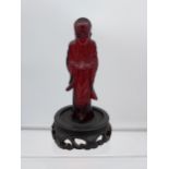 A 19TH Century Chinese hand carved Cherry amber buddha figurine with a hand carved wooden base. [