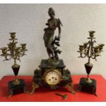 A Three piece 19th century French mantle clock and candelabra set, made with a bronze effect spelter