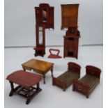 A Selection of antique dolls house furniture items to include beds, secretaire, table and wardrobe