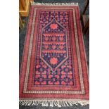 An ornate hand woven Persian rug [206x114cm]