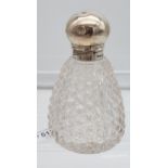 A Birmingham silver topped and cut glass base perfume bottle. [14cm in length]