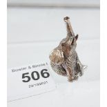 A silver figure of a trumpeting elephant. [3.4cm in height]