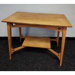 An Arts and crafts light oak two tier window table.