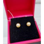 A pair of fresh water pearl stud earrings with silver posts