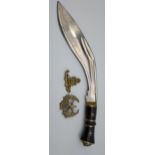 Kukri knife together with two military cap badges.