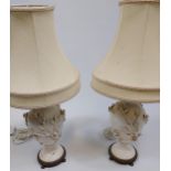 A Pair of antique blanc de chine floral design table lamps