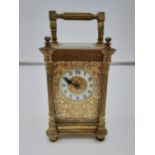An ornate Antique Gilt brass and bevel glass carriage clock, In a working condition. [13.5cm in