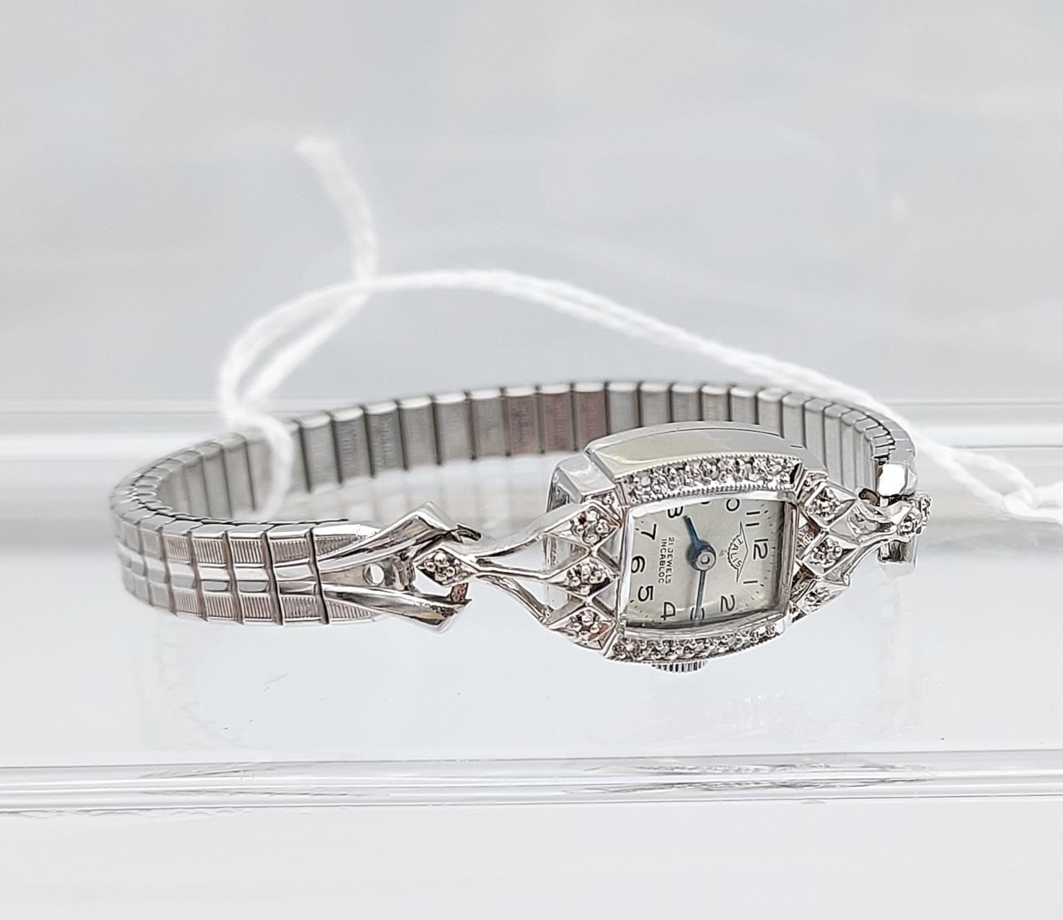 An Art Deco 14k white metal and diamond ladies wrist watch produced by Talis, 21 jewels Incabloc.