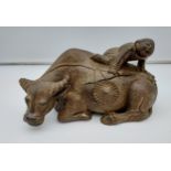 Antique hand carved Chinese figure climbing a buffalo. [33cm in length]