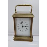 Antique Brass and bevel edge glass carriage clock. In a working condition. [15cm in height- handle