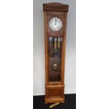 An oak cased Grandfather clock, with hand carved foliage design to the upper section, silver and