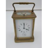 A large antique Brass and bevel glass carriage clock. In a working condition. Has Double barrel