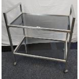 A Mid century stainless steel and black glass two tier trolley.