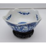 A 20TH CENTURY Chinese blue and white pattern bowl, signature to the base. Comes with wooden