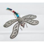 A large dragonfly brooch with ruby eyes & semi precious stone body