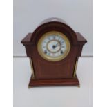 An Edwardian mahogany cased mantle clock. In a working condition [34cm in height]