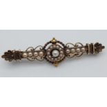 A Victorian Yellow metal bar brooch set with seed pearls. Stamp rubbed. [5.77grams]