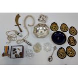 A Selection of military items to include cap badges, patches, trench art letter opener, RAF