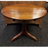 A 19th century Snap top table designed on a turned column support off set by the supporting legs.
