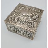 An ornate silver hallmarked cigarette box. [6x9x9cm]