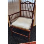 Victorian arts and crafts chair, spindle back and arm supports, raised on turned legs and