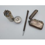 A Silver plated gun shell shaped counter holder, Plated vesta style case containing counters and