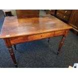 Stained farmhouse pine table with a single drop leaf opposite a single drawer, raised on turned legs