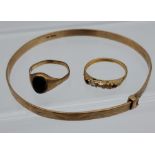 A 9ct gold bangle, 9ct gold signet ring and 18ct gold ring [missing stones] [9ct- 8.92grams] [