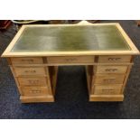 Early 20th century heavy pine desk, rectangular top with green leather top above a central drawer