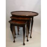 Nest of three wooden tables with pie crust edging, slender supports ending in pad feet [54.5cm]