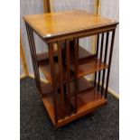 Mahogany revolving bookcase, square shaped top above open shelves to each side, raised on a