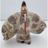 A 19th century Satsuma figure of a Scholar wearing a mask, kimono gown and holding a fan.