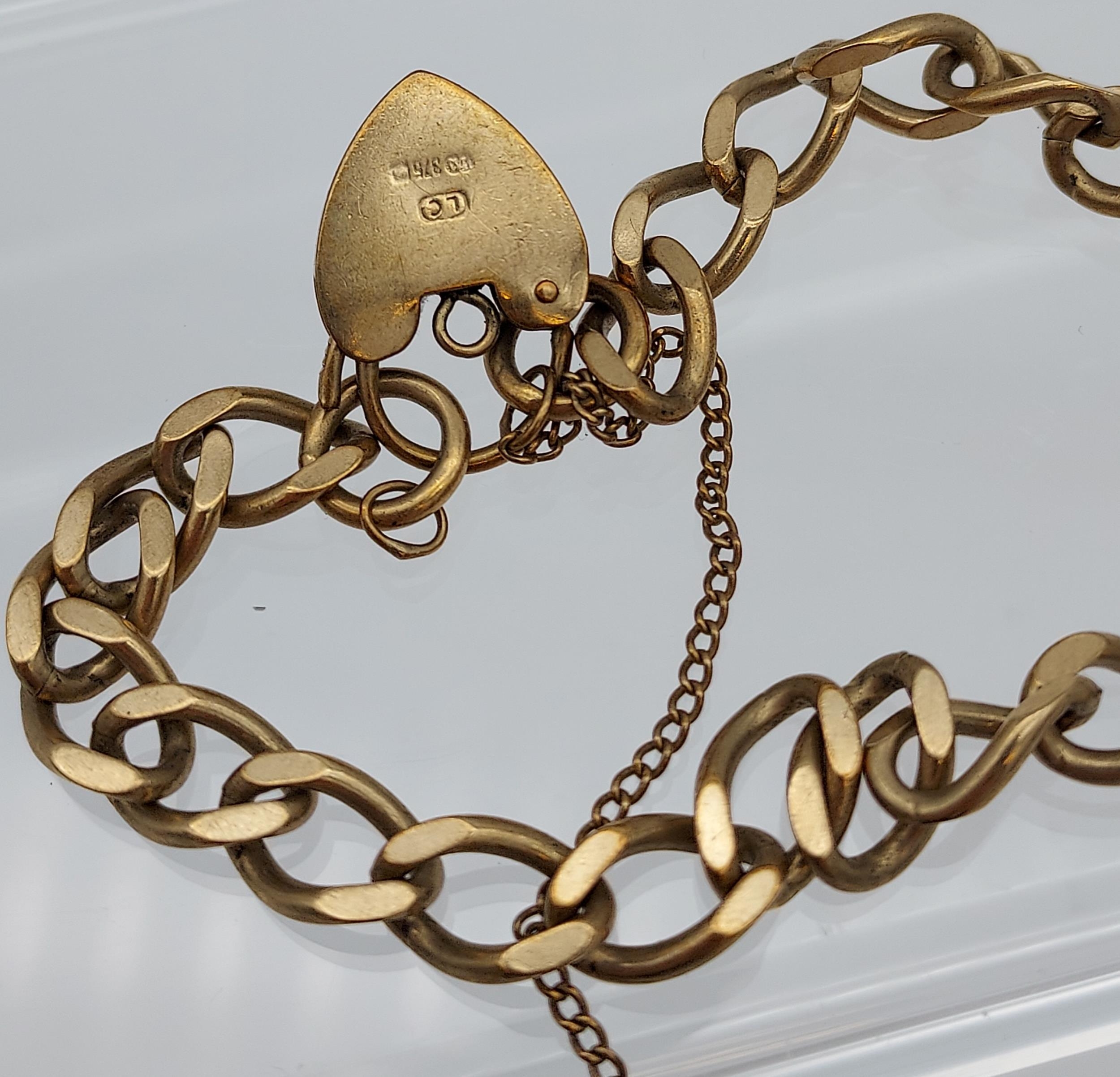 A 9ct gold curb bracelet with heart locket. [13.84grams] - Image 2 of 2